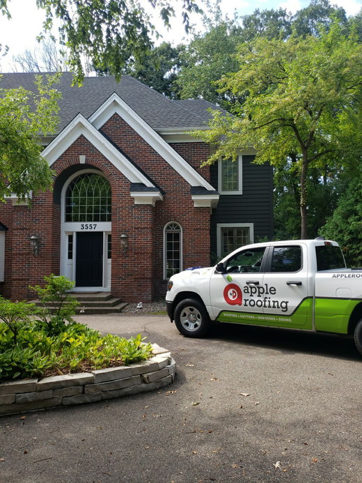 Apple-Roofing-Truck-Homeowner-Drivway-Brick-Home.jpeg