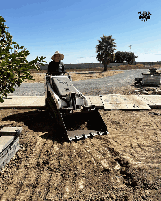 Landscaper preparing soil base for turf installation in Stockton.png