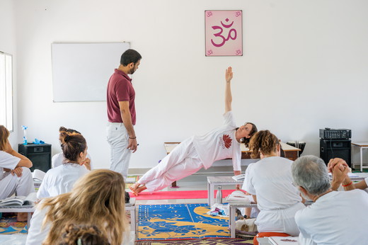 Ram Jain guide yoga postures to Students in Class.jpg