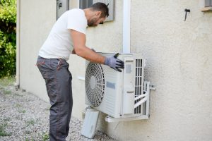 Technician-installing-ac-unit-300x200.jpg