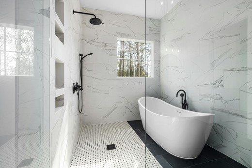virginia-beach-bathroom-remodel-freestanding-tub-marble-walls-black-floor.jpg