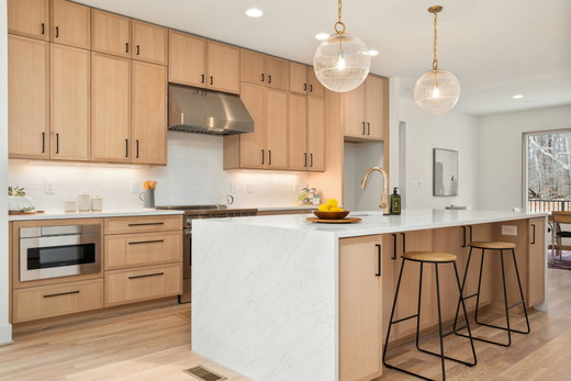 virginia-beach-kitchen-remodel-oak-cabinets-waterfall-island-gold-pendants.jpg